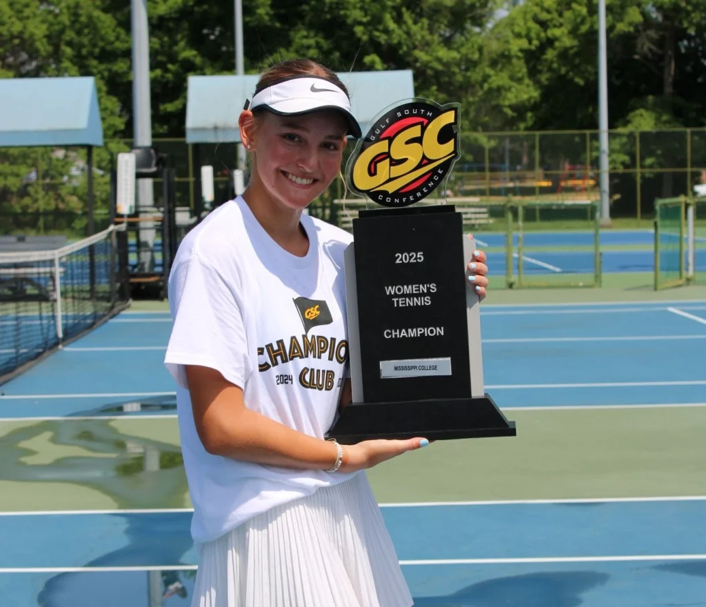 Katharina Weber proudly posing with the Conference Champions trophy.